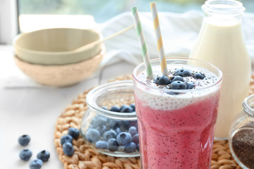 Smoothie with chia seeds in glass on table