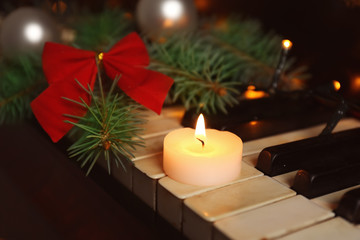 Fototapeta na wymiar New year decorations on piano keyboard. Christmas music concept