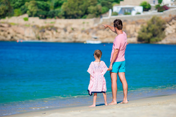 Happy father and little girl on beach