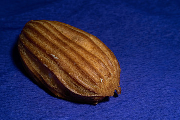 Eclair with cream on a violet background