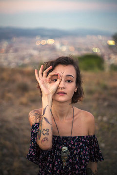 Tattooed alternative girl gesturing