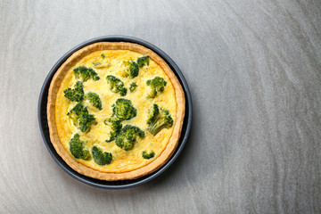 Tasty broccoli quiche on table