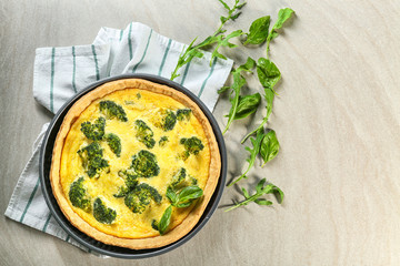 Tasty broccoli quiche on table