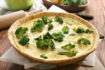 Tasty broccoli quiche on table, closeup