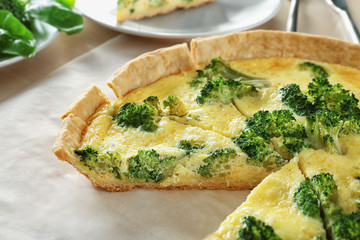 Tasty broccoli quiche on table