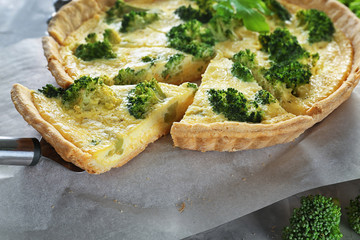 Tasty broccoli quiche on table