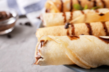 Delicious pancakes with chocolate sauce, closeup