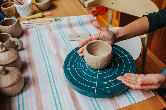 woman make ceramics on pottery wheel