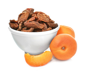Dried and fresh apricots on white background