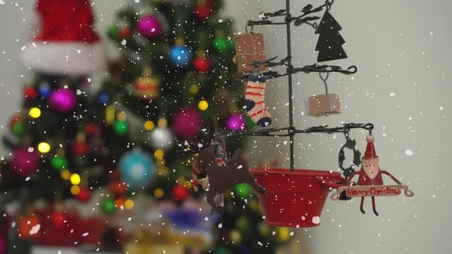 Greeting Season concept.Dolly of ornaments on a Christmas tree with decorative light and falling snow in 4k (UHD)