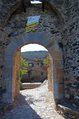 Naklejka premium Street in french village of Castelnou in Pyrenees orientales, France