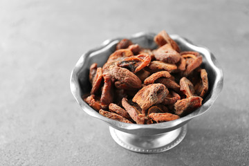Dried apricots in bowl on table