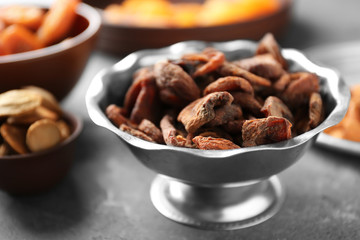 Dried apricots in bowl on table