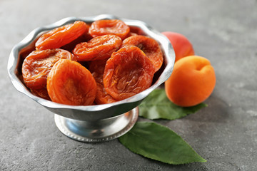 Dried apricots in bowl on table