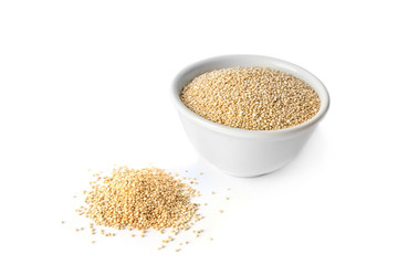 Raw quinoa grains in bowl on white background