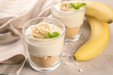Glasses with yummy banana pudding on kitchen table