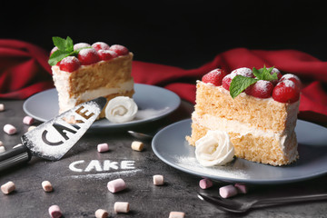 Composition with delicious cake, marshmallows and sugar powder on grey background