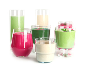 Glasses with different smoothies on white background