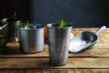 Metal glass with mint julep on kitchen table