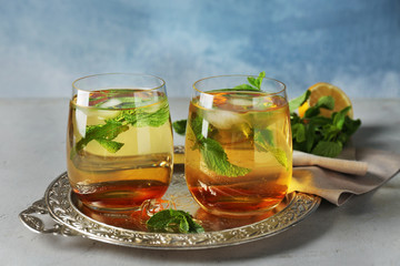 Two glasses with mint julep on metal tray