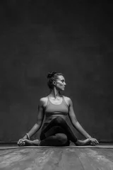 Tuinposter Young beautiful yoga female posing in studio © Alexander Y