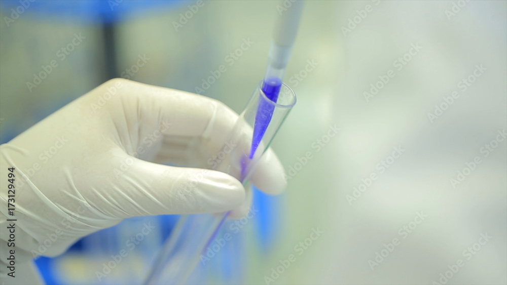 Poster test tubes closeup. medical equipment. close-up footage of a scientist using a micro pipette in a la