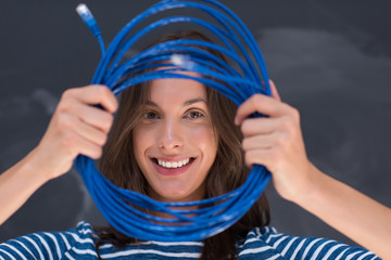 woman holding a internet cable in front of chalk drawing board