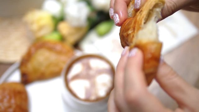 Woman Hand Tearing Off Croissant Having Breakfast With Coffee. Closeup. Slow Motion. HD, 1920x1080. 