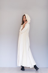 Fototapeta premium woman in a white coat with hood isolated on white background