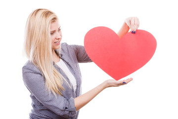Woman holding big red heart, love sign