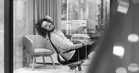 businessman sitting with legs on desk