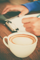 hand writing with cup of coffee