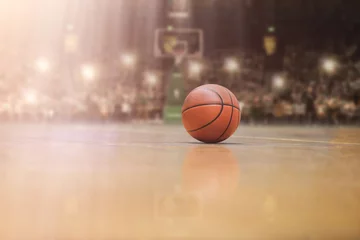  basketball ball in front of big modern basketball arena © .shock