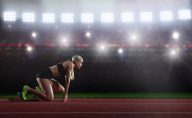 woman  sprinter leaving starting blocks