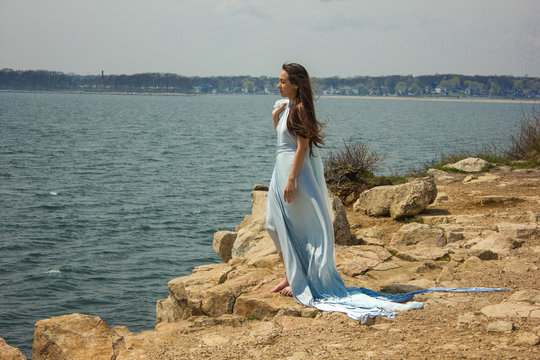 Girl in blue dress on a cliff 3
