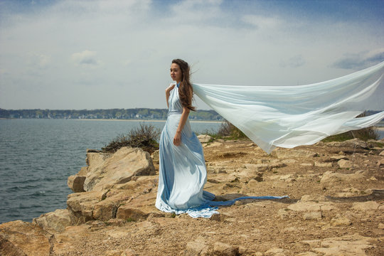 Girl in blue dress on a cliff 1