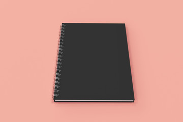 Closed notebook spiral bound on red background