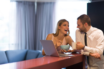 A young couple is preparing for a job and using a laptop