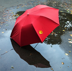 Red umbrella on a street.