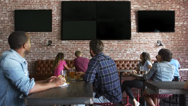 Friends Watching Game In Sports Bar On Screens Shot On R3D