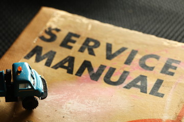 Model car scene put on the old service manual book.