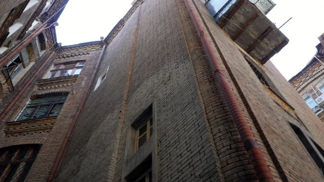 Facade of old european building. Historic countryard. Architecture concept. 4k. Gimbal shot