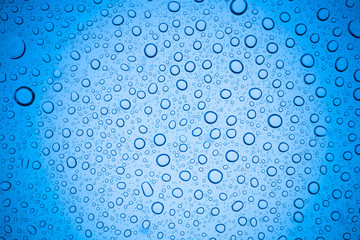 Rain droplets on blue glass background, Water drops on glass.