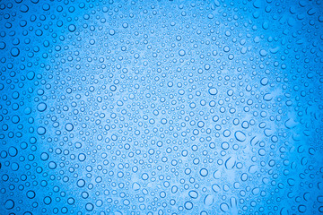 Rain droplets on blue glass background, Water drops on glass.