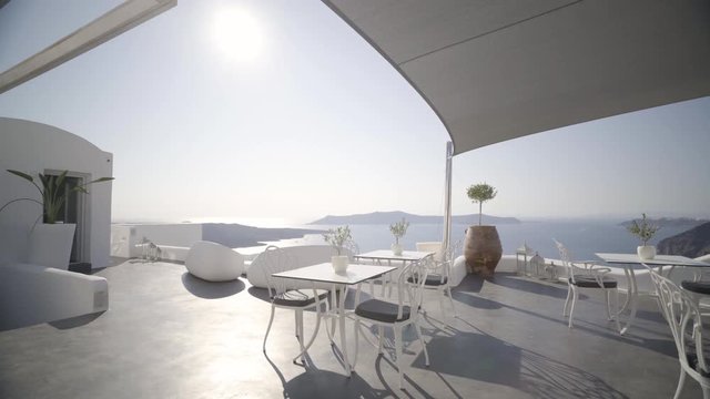 4k travel video dolly move outdoors on modern terrace of luxury restaurant in santorin greece on sunny day without people