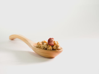 crispy cereal flakes in Wooden spoon isolate on white background