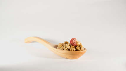 crispy cereal flakes in Wooden spoon isolate on white background