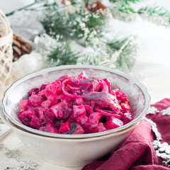 Obraz na płótnie Canvas Beet salad with herring and apples on wooden background,square