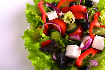 salad from fresh vegetables in a plate on a table, selective focus