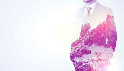 Businessman standing with mountain graphic